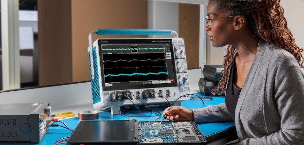 An engineer testing power integrity with a Tektronix oscilloscope