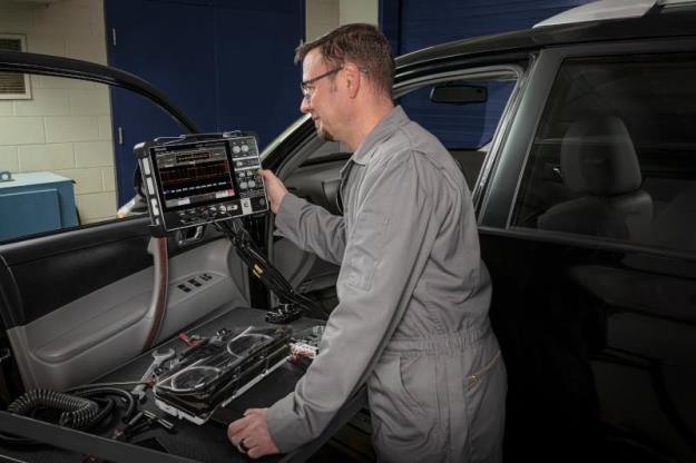Automotive engineer testing CAN bus with 2 Series mixed signal oscilloscope