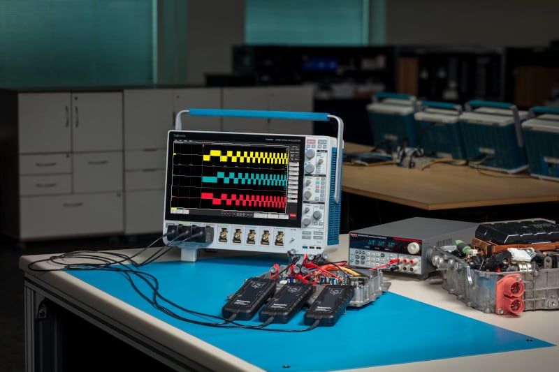 Bench set up for an IMDA 3 phase motor drive test showing an oscilloscope and three THDP0400 probes connected to an automotive DUT