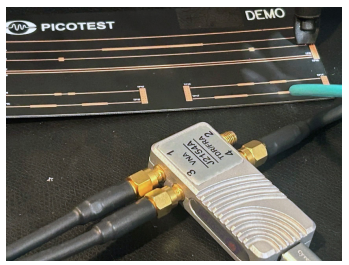 TDR measurement setup with a Picotest probe connected to a printed circuit board test fixture.