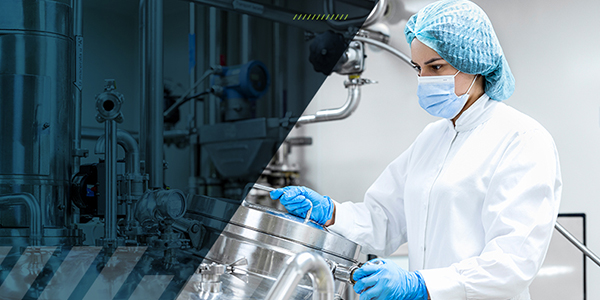 A medical researcher working with stainless steel industrial equipment in a high-tech laboratory setting