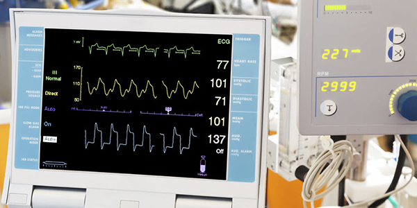 A medical monitor displaying vital signs in a clinical setting