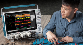 Engineer working at a bench with a 5 Series MSO oscilloscope looking at the screen