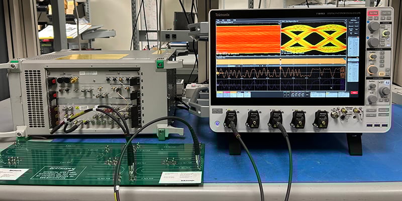 Test set up on a bench in an engineering lab showing a BERT scope connected to a PRBS board and the 7 Series DPO oscilloscope to measure the test results.